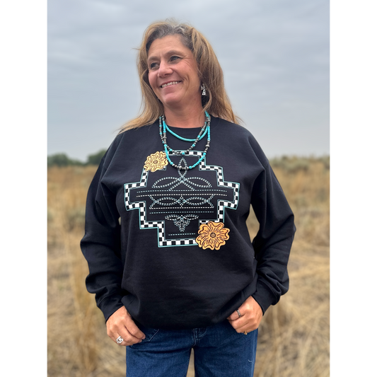 Woman wearing a black sweatshirt with a boot stitch design. 